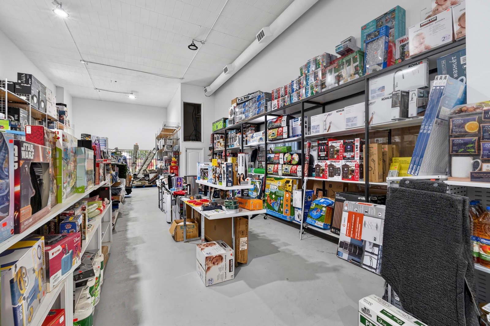 Wide view down a Costo Cost Liquidation aisle packed with boxed stock